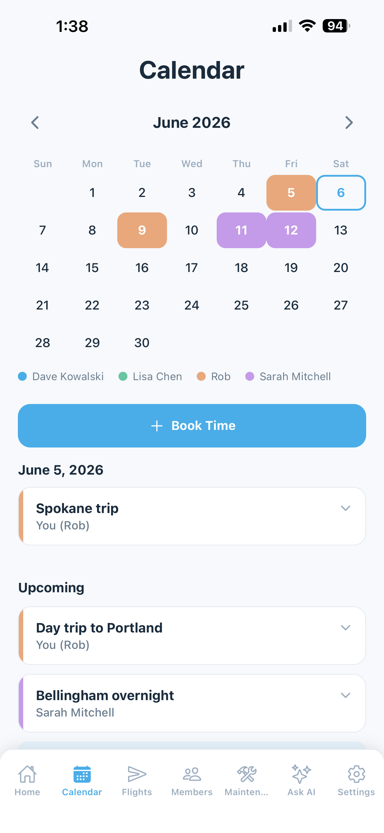 Shared scheduling calendar showing member bookings across the month